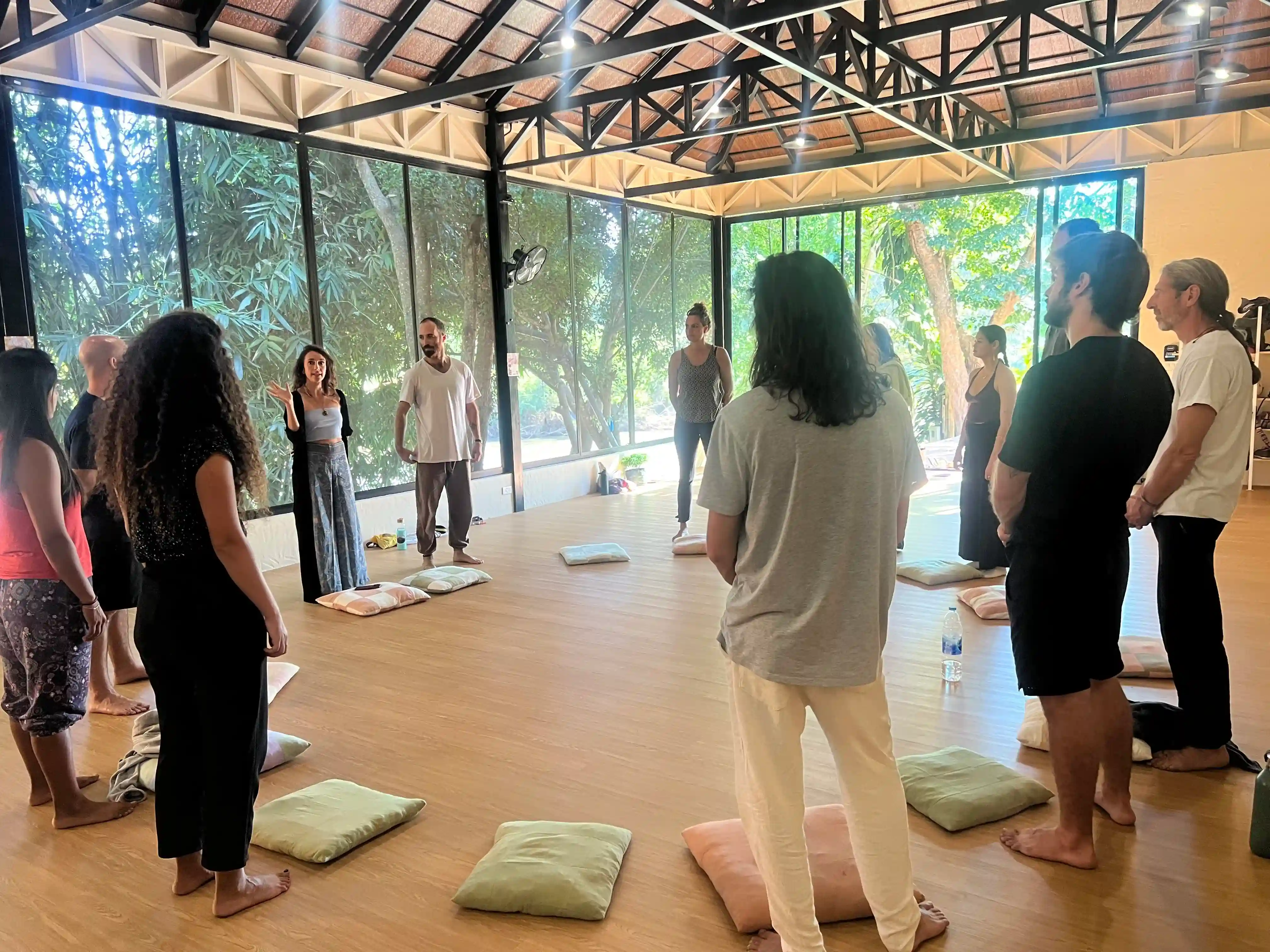 Group breathwork session with participants lying on meditation mats